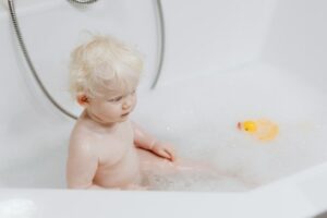 Baby having a bath in clean water due to Houston water filter system