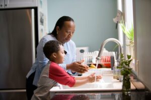 Grandma and grandson using tap water made safe with home water filtration systems