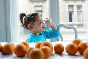 Little girl drinking water after Houston whole house water filter installation from Southern Water Solutions.